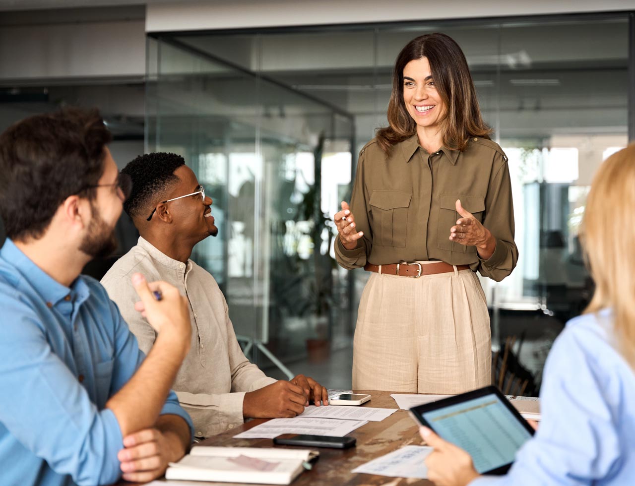 Business leader discussing ideas with colleagues during a collaborative team meeting