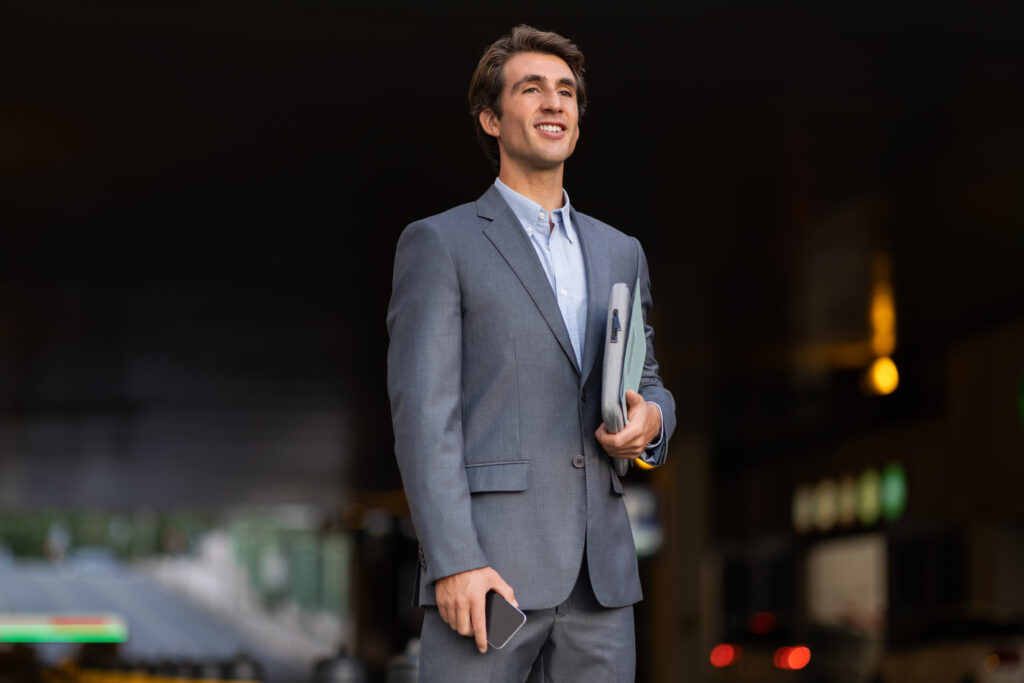 A business professional standing confidently outside the office.