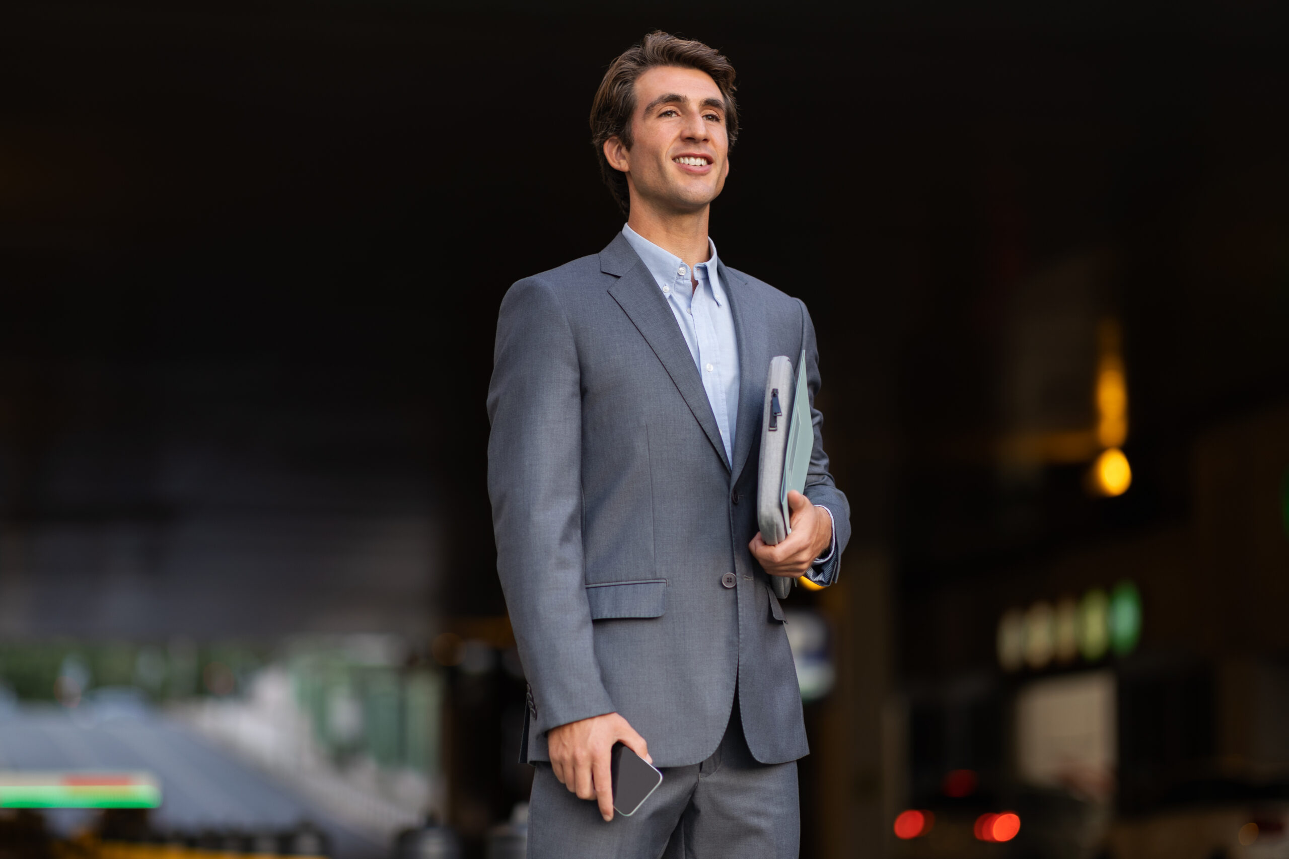 A business professional standing confidently outside the office.